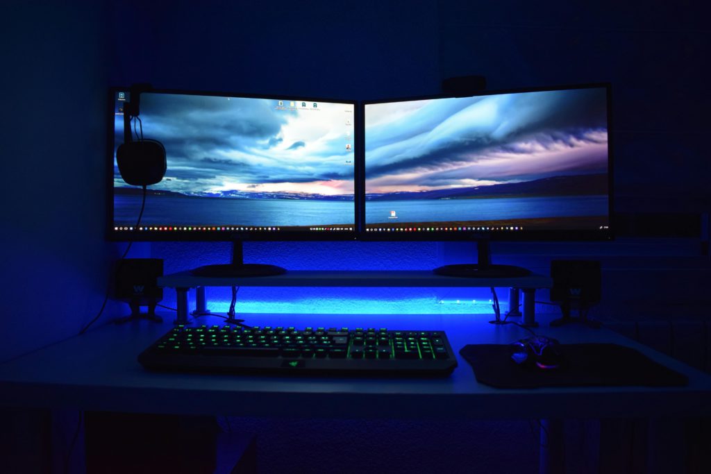 pexels-photo-777001-777001 Dual monitors with blue lighting on a gaming desk setup.